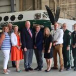 Representatives of Bangor Savings Bank and LifeFlight pose in front of a LifeFlight airplane
