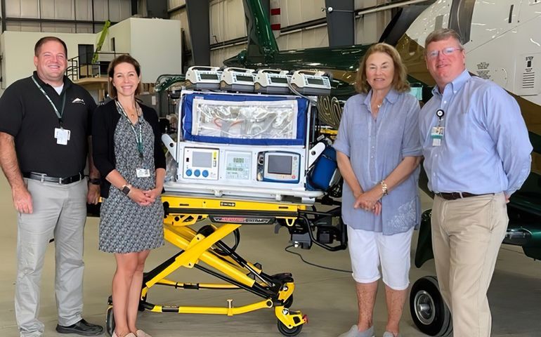 From left, Director of Clinical Operations Chuck Hogan, Director of Development Anna Dugal, CCRF Director Laurie Warren and COO Bill Cyr, flanking an isolette (or incubator) on a recent visit to LifeFlight of Maine’s Bangor base.