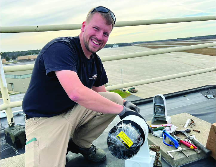 John Rolfson installing a new runway camera on top of the tower at the Brunswick Executive Airport.