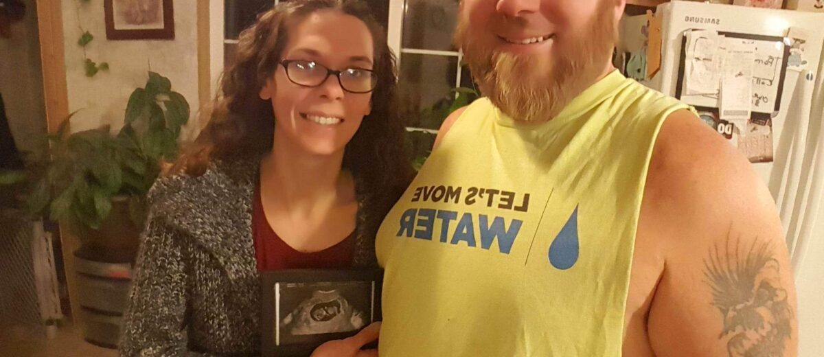 Eugene & wife Tiffany with ultrasound of first child on the way