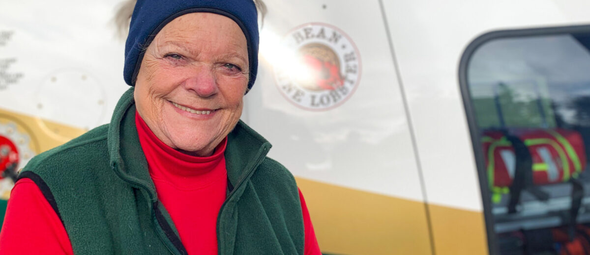 Linda Bean standing next to a LifeFlight helicopter