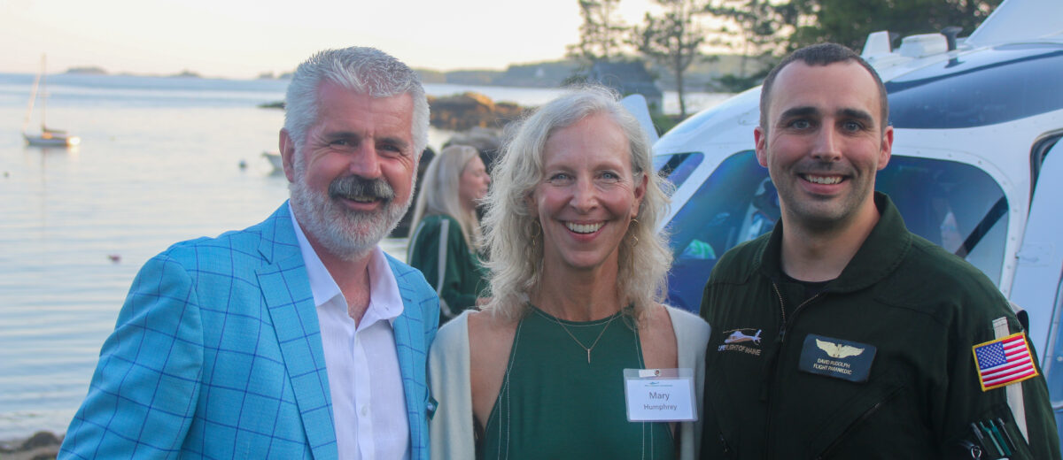 David Humm with his wife, Mary Humphrey, and a LifeFlight crew member at an event at their home in Pemaquid, July 2023.