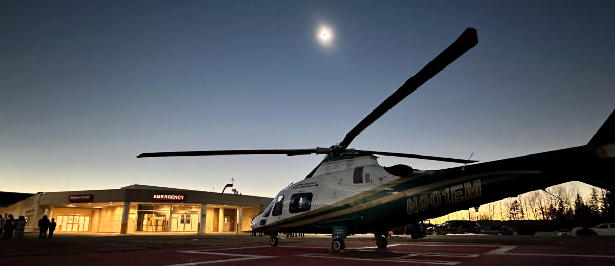 A LifeFlight helicopter sits on the helipad at Houlton Regional Hospital during the solar eclipse on April 8, 2024.
