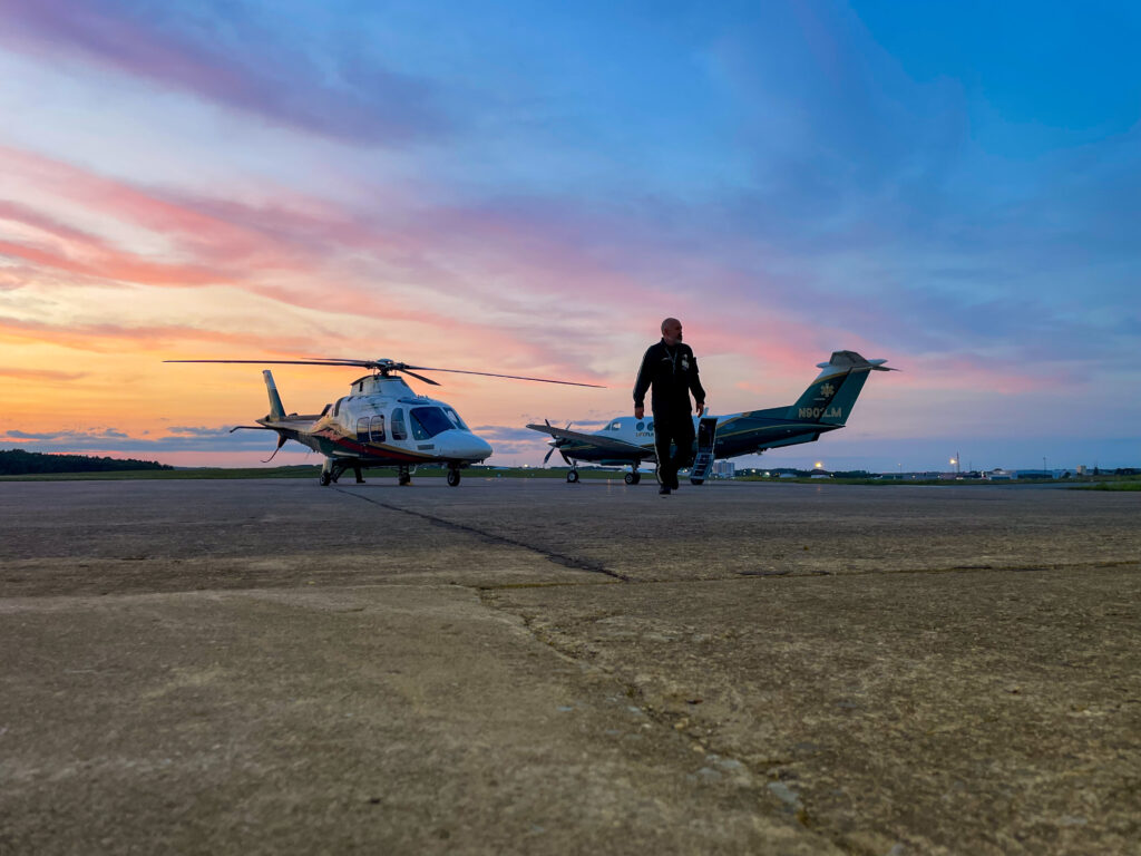 LifeFlight helicopter and plane at sunset.