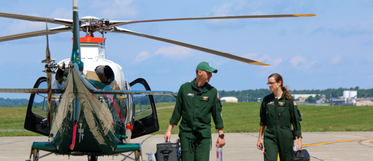 LifeFlight crew members next to a helicopter.