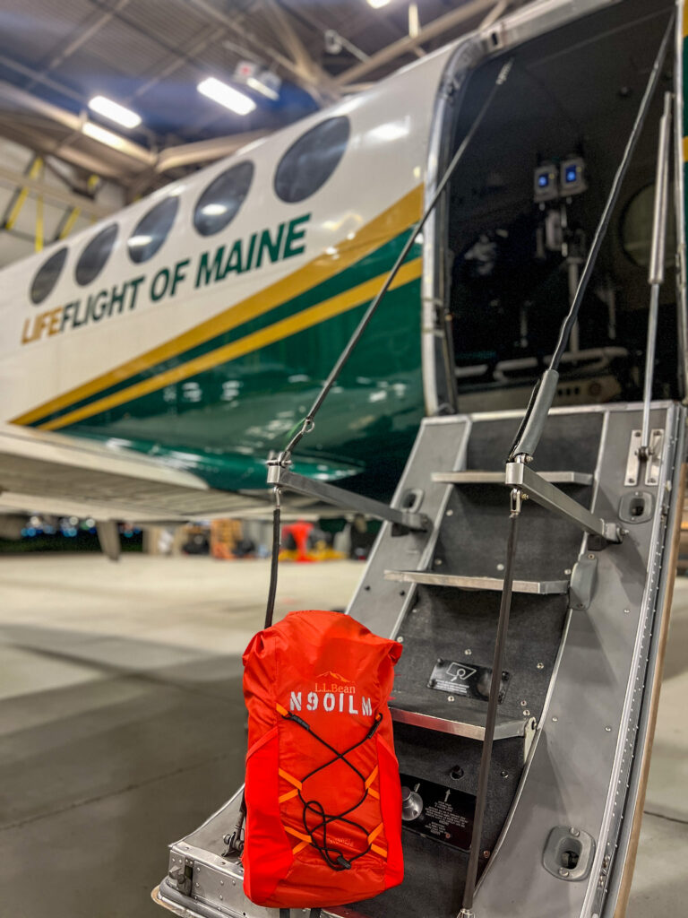 A LifeFlight safety and survival kit on the steps of LifeFlight's plane.