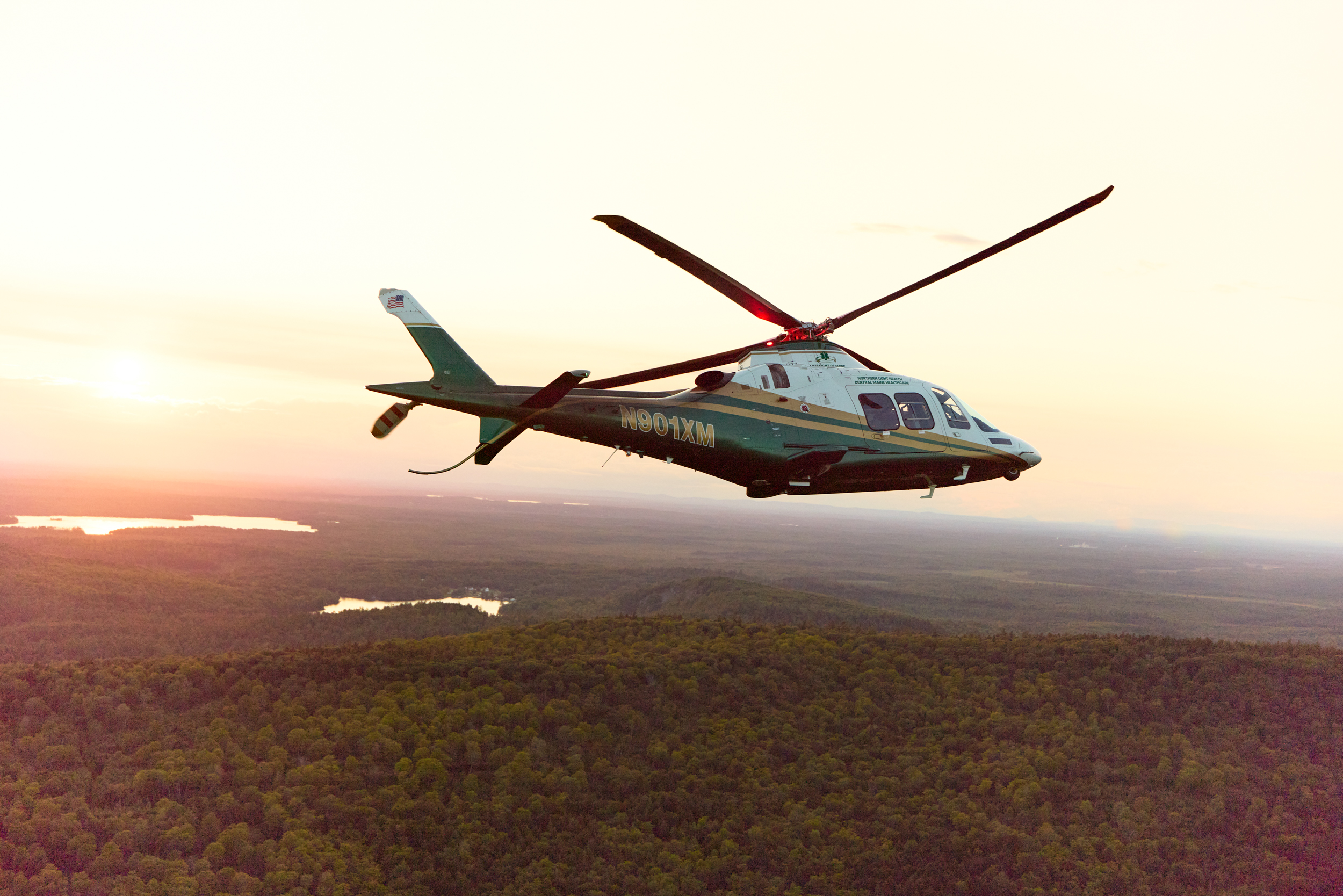 Helicopter flyer over Maine at sunset