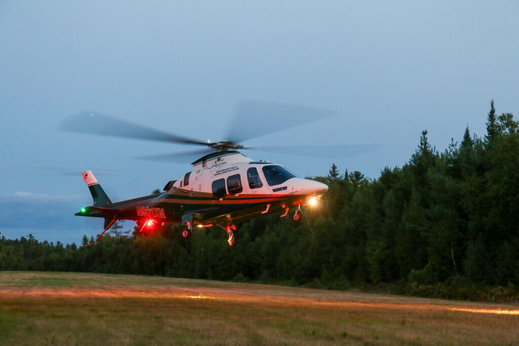 LifeFlight helicopter landing at dusk.